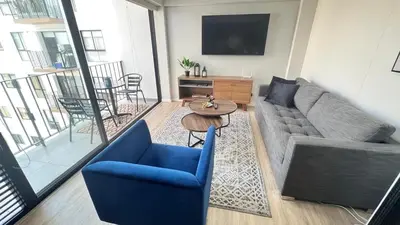 a living room with a couch and a table at Miraflores Deluxe in Lima