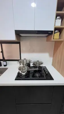 a stove top with four pots and pans on it at Miraflores Deluxe in Lima