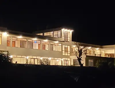 a large building with lights on it at night at Hotel Casa Suite Inka in Ollantaytambo
