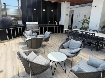 a waiting room with chairs and tables and a table at New apartment in Barranco in Lima