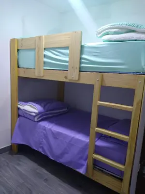 a couple of bunk beds with a purple bed at Apartamento 3D de estreno muy céntrico in Lima