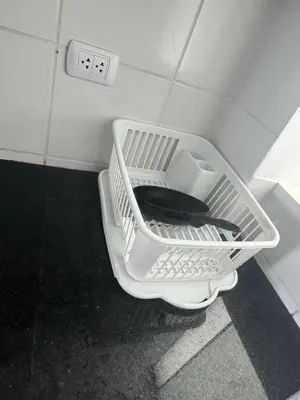 a white basket in a bathroom with a toilet at Beautiful apartment with an ocean view in San Bartolo