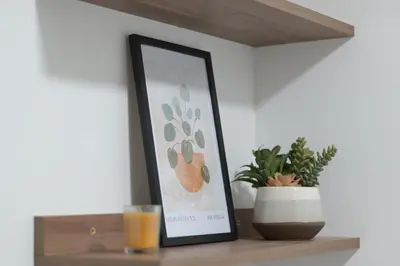 a picture on a shelf with a drink and a plant at Cozy apartment in Barranco in Lima