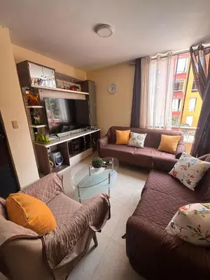 a living room with two couches and a tv at Departamento in Lima