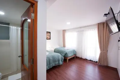 a hotel room with a bed and a window at Carmen's House in Cusco