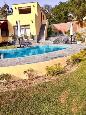a house with a swimming pool in front of a house at Casa Trasgu en Cieneguilla Lima Peru Nice and cozy cottage in Villa María del Trunfo