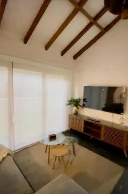 a living room with a large flat screen tv at Casa Trasgu en Cieneguilla Lima Peru Nice and cozy cottage in Villa María del Trunfo