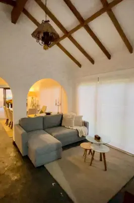 a living room with a blue couch and a table at Casa Trasgu en Cieneguilla Lima Peru Nice and cozy cottage in Villa María del Trunfo