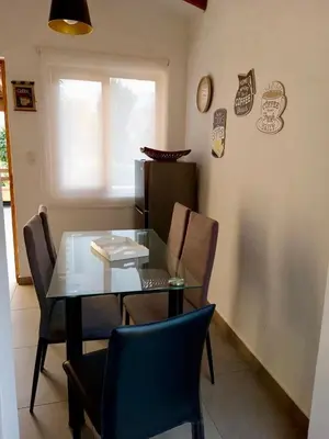 a dining room with a glass table and chairs at Casa Trasgu en Cieneguilla Lima Peru Nice and cozy cottage in Villa María del Trunfo