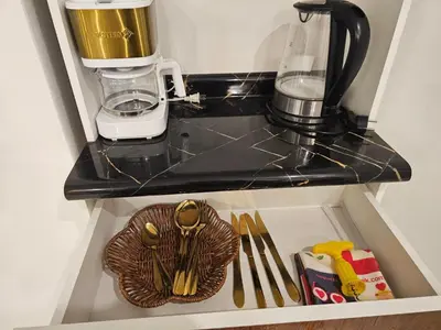 a coffee maker sitting on top of a shelf at Familiar Premium Twin Chanchamayo in La Merced