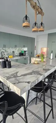 a large table in a kitchen with two chairs at SKY HOUSE con vista al mar in Chincha Baja
