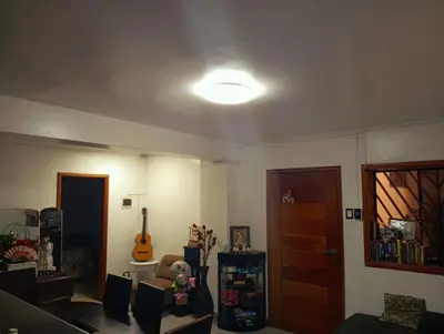 a living room with a light on the ceiling at Colibri - Hab Triple in Lima