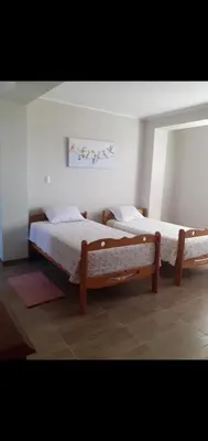 two beds are in a room with at Noah'house in Nazca