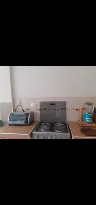 a kitchen with a stove and a counter top at Noah'house in Nazca