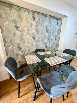 a dining table and chairs in front of a wall at Ocean view 1 BR Miraflores with parking in Lima