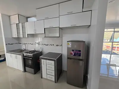 a kitchen with white cabinets and a stainless steel refrigerator at 501 Modern equipped department 3 in Abancay
