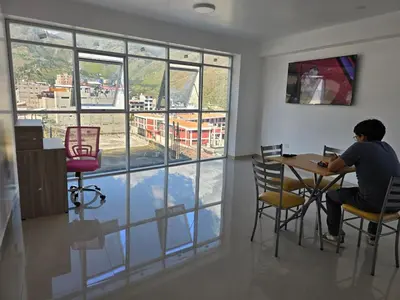 a man sitting at a table with a laptop at 501 Modern equipped department 3 in Abancay