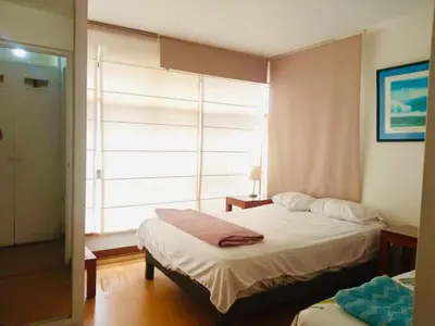 a bedroom with two beds and a window at Miraflores Larco in Lima