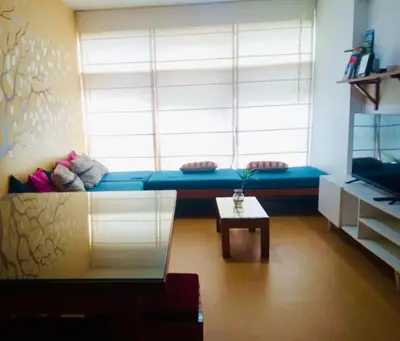 a room with a blue couch in front of a window at Miraflores Larco in Lima