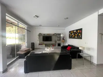 a living room with two couches and a tv at Refugio en Cieneguilla relax, piscina y sol in Cieneguilla