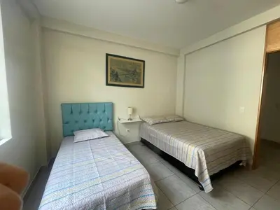 a bedroom with two beds and a picture on the wall at Refugio en Cieneguilla relax, piscina y sol in Cieneguilla