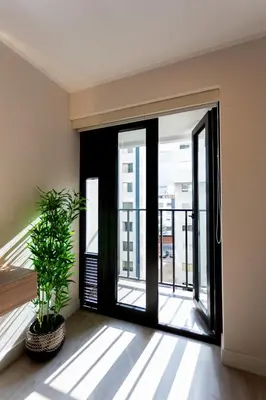 an open door with a plant in a room at Brand-new designer apt - Pool in Miraflores in Lima