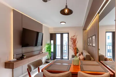 a living room with a table and a tv at Brand-new designer apt - Pool in Miraflores in Lima