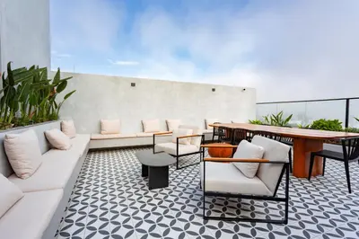 a living room with a white couch and a table at Brand-new designer apt - Pool in Miraflores in Lima