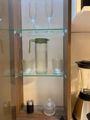 a glass shelf with glasses and a blender at Amanecer Refugio Ideal Cozy Retreat in Los Olivos in Lima