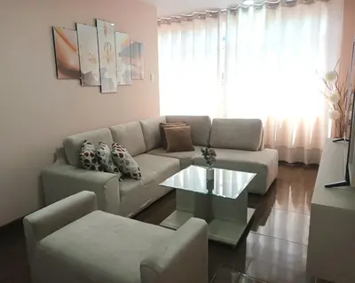 a living room with a couch and a coffee table at Katty's apartment - Las Malvas in Lima