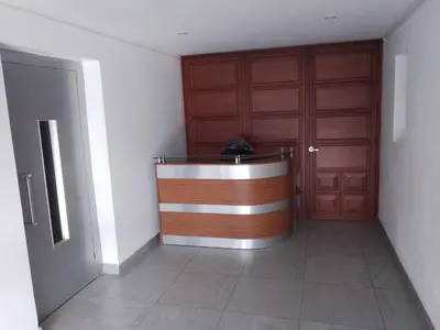 a room with two wooden doors and a reception desk at Miraflores, Lima, habitación independiente in San Antonio