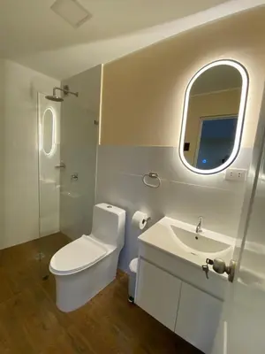 a bathroom with a toilet and a sink and a mirror at Brisa Dorada - Luxury Apartment in Los Olivos in Lima