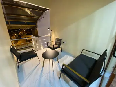 a room with two chairs and a table and a table and chairs at Brisa Dorada - Luxury Apartment in Los Olivos in Lima