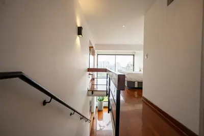 a staircase leading to a bedroom with a bed at Luxury Duplex Stunning Golf Views - Prime Location in Lima