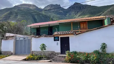 a house with a mountain in the background at Casa Aguilar in Urubamba