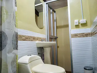 a bathroom with a toilet and a sink and a mirror at Casa Aguilar in Urubamba