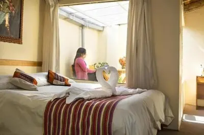 a bedroom with a bed with two swans on it at Andean Dreams 1 in Cusco