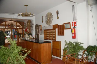 a restaurant with a counter in a room with plants at Hotel WhiteHouse in Cusco