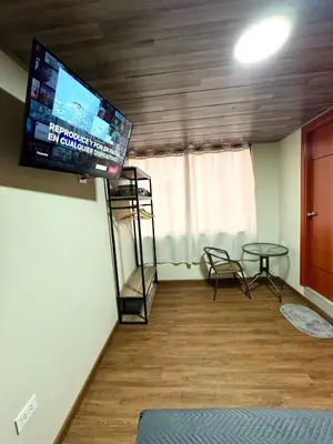 a living room with a flat screen tv on the wall at Casa Cusco in Cusco
