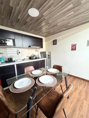 a dining room with a table and chairs in a kitchen at Casa Cusco in Cusco