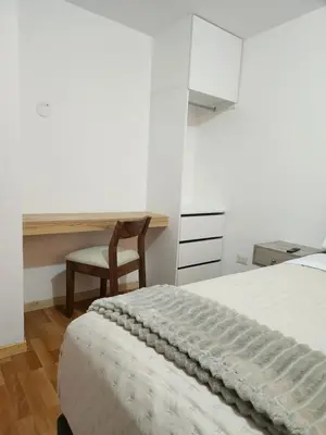 a bedroom with a bed and a desk and a chair at Casa Victoria in Lima