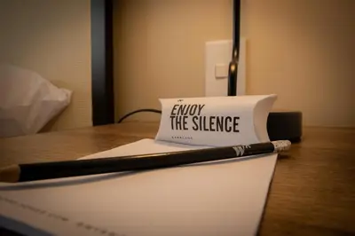 a sign that says enjoy the silence with a pen on a desk at Salaverry by Wynwood House in Lima