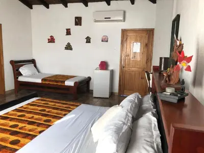 a bedroom with a bed and a couch in it at Magnum House in Huancayo