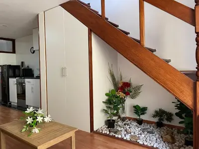 a living room with a staircase with potted plants at SAELUMA Suite Apart in Lima