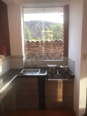 a kitchen with a sink and a window at Casa de Marguito in Urubamba