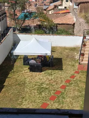 a white tent sitting on top of a grass field at 7 Borreguitos GUESTHOUSE in Cusco