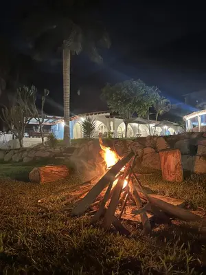 a fire pit in the grass at night at QPÑ Hoteles - Hacienda Nieve Nieve in Balconcillo de Aviyay
