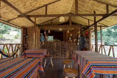a room with two tables and chairs in a building at Viamonte EcoLodge in Santa Teresa
