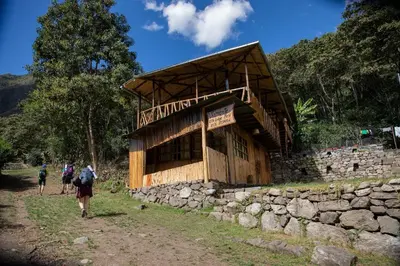 people walking in front of a building on a trail at Viamonte EcoLodge in Santa Teresa