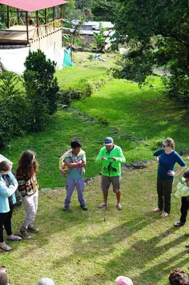 a group of people standing around in the grass at ALPHINA CABINS Qhapaq Ñan in Sahuayacu